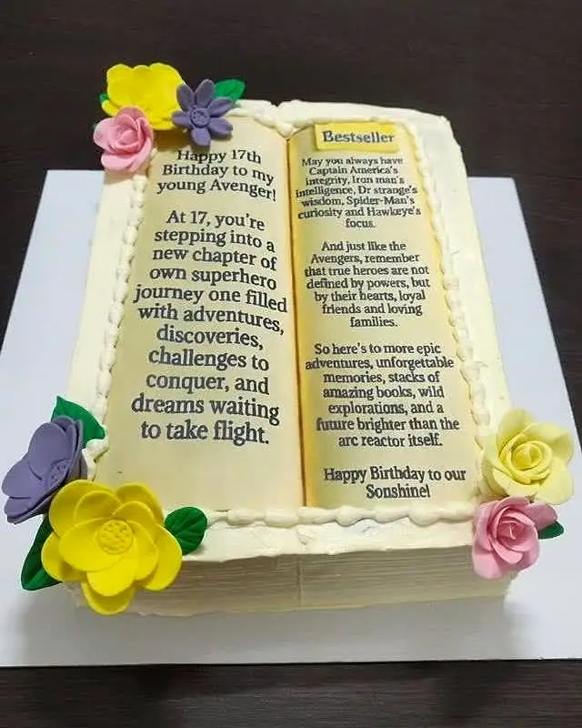 Book theme cake with a birthday message and sugar flowers